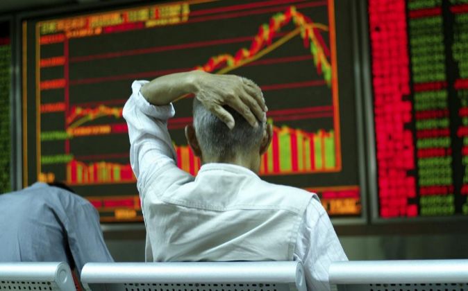 Un inversor revisa una pantalla en la Bolsa de Shanghai (China).