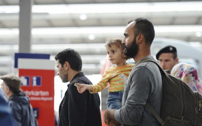 Un grupo de refugiados sirios espera un tren en la estación de...