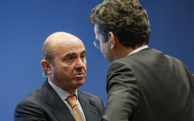 El ministro de Economía español, Luis de Guindos (i), habla con el...