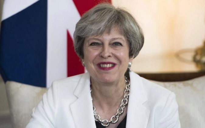 La primera ministra del Reino Unido, Theresa May, sonríe durante un...