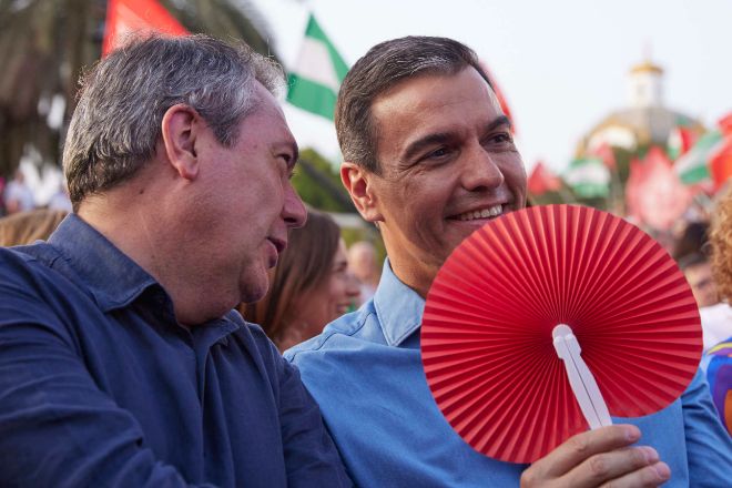 El presidente del Gobierno de España, Pedro Sánchez (d) con un abanico para combatí el calor, junto al candidato del PSOE a la presidencia de la Junta de Andalucía, Juan Espadas, (i).