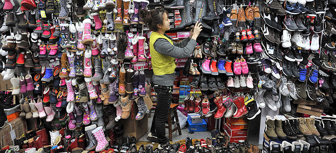 Una vendedora espera clientes en un puesto del mercado de zapatos en Shenyang, al nordeste de China, el 4 de diciembre de 2009. Empresas y gobierno en China han mostrado su descontento a que la Unin europea prolongue los aranceles contra el calzado y el cuero en un 16,4 por ciento durante quince meses ms. Aseguran adems que los perjudicados no slo seran los productores asiticos sino tambin el comercio europeo. EFE/ Mark